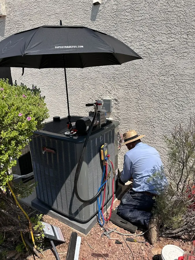HVAC technician performing outdoor AC maintenance in Lynn Haven